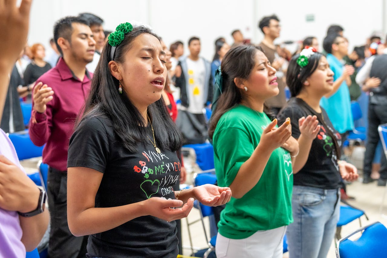 A joyful group worships in a lively Christian gathering in Mexico City, showcasing vibrant traditions.